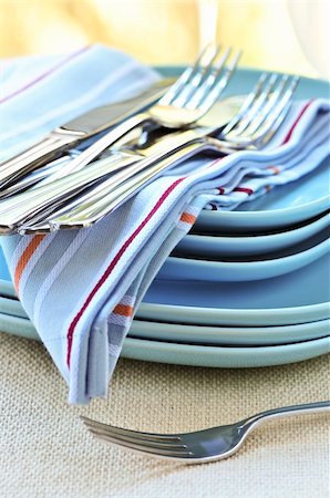 Table setting with stack of plates and cutlery Stock Photo - Budget Royalty-Free & Subscription, Code: 400-04083792