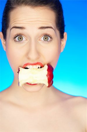 simsearch:400-04083912,k - Portrait of beautiful woman with apple core in mouth Stock Photo - Budget Royalty-Free & Subscription, Code: 400-04083896