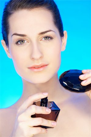 simsearch:400-09081321,k - Portrait of 20-25 years old beautiful woman with bottle of perfume Stock Photo - Budget Royalty-Free & Subscription, Code: 400-04083913