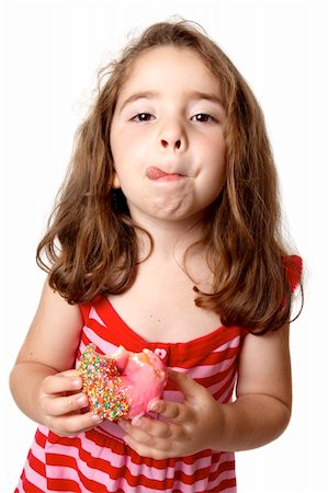 A little girl in a red striped dress is  holding a pink iced doughnut and licking her lips with satisfaction. Stock Photo - Budget Royalty-Free & Subscription, Code: 400-04094341