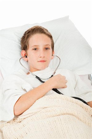 pneumonia - Little boy sick in bed listens to his heartbeat with a stethoscope.  White background. Stock Photo - Budget Royalty-Free & Subscription, Code: 400-04094591
