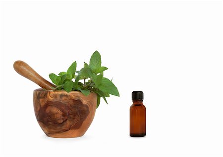 simsearch:400-04085229,k - Chocolate mint herb leaves in an olive wood mortar with pestle and aromatherapy essential oil bottle, over white background. Foto de stock - Royalty-Free Super Valor e Assinatura, Número: 400-04094874