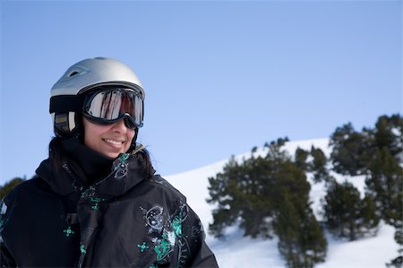 extreme cold clothes women - Pretty gorl in snowboard clothes in helmet over blue sky Stock Photo - Budget Royalty-Free & Subscription, Code: 400-04096939