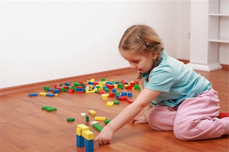 Adorable girl playing with blocks Stock Photo - Budget Royalty-Free & Subscription, Code: 400-04097379