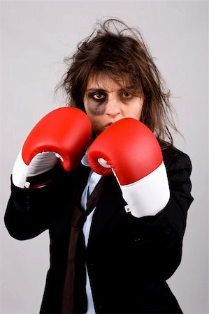 simsearch:400-05898249,k - businesswoman wearing boxing gloves with bruised eye. grey background. Stock Photo - Budget Royalty-Free & Subscription, Code: 400-04097402
