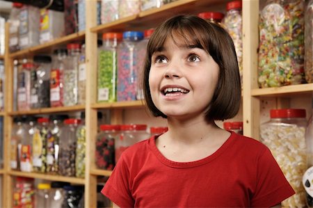 spoiled for choice - young girl smiling in awe at rows of sweets Stock Photo - Budget Royalty-Free & Subscription, Code: 400-04097625