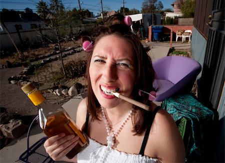 Hispanic woman in front of house with messy yard Stock Photo - Budget Royalty-Free & Subscription, Code: 400-04099376