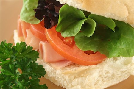 simsearch:400-04613511,k - Freshly prepared ham and salad roll with sesame seeds. Fotografie stock - Microstock e Abbonamento, Codice: 400-04090493
