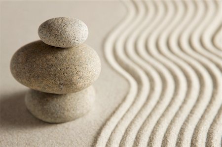 Stack of stones on raked sand. Zen concept. Shallow depth of field. Stockbilder - Microstock & Abonnement, Bildnummer: 400-04090563