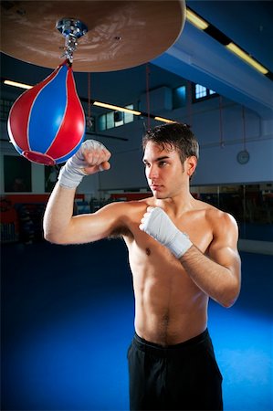 punching bag - young adult man hitting speed bag in gym. Copy space Stock Photo - Budget Royalty-Free & Subscription, Code: 400-04091968