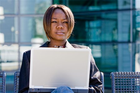 simsearch:400-04540351,k - African american business woman with a computer notebook browsing outside an office building Stock Photo - Budget Royalty-Free & Subscription, Code: 400-04091999