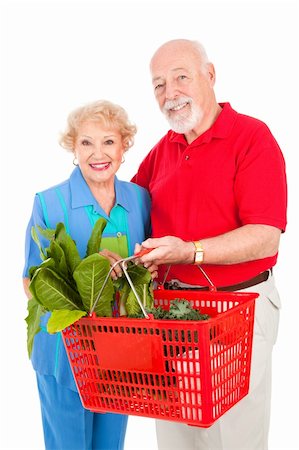 Senior couple shopping for healthy organic fruits, vegetables and soups.  Isolated on white. Stock Photo - Budget Royalty-Free & Subscription, Code: 400-04092039