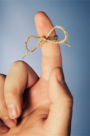 finger knot reminder - A piece of string tied around index finger Stock Photo - Budget Royalty-Free & Subscription, Code: 400-04092629