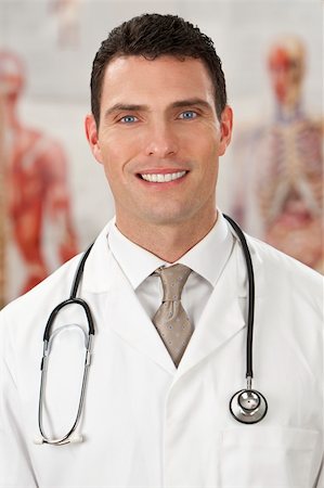 simsearch:400-04217553,k - A male doctor with medical charts out of focus behind him. Foto de stock - Royalty-Free Super Valor e Assinatura, Número: 400-04093341