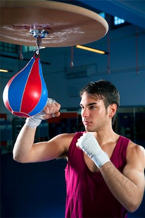 punching bag - young adult man hitting speed bag in gym. Copy space Stock Photo - Budget Royalty-Free & Subscription, Code: 400-04093530