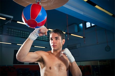 punching bag - young adult man hitting speed bag in gym. Copy space Stock Photo - Budget Royalty-Free & Subscription, Code: 400-04093531