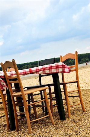 simsearch:851-02960697,k - Dining table and chairs set outside on a beach Stock Photo - Budget Royalty-Free & Subscription, Code: 400-04093549