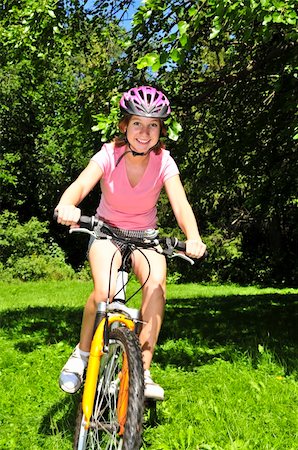 simsearch:400-04890875,k - Portrait of a teenage girl riding a bicycle in summer park outdoors Stock Photo - Budget Royalty-Free & Subscription, Code: 400-04093553
