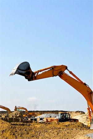 simsearch:400-05326745,k - Yellow bulldozer machines digging and moving earth at construction site Foto de stock - Royalty-Free Super Valor e Assinatura, Número: 400-04093605