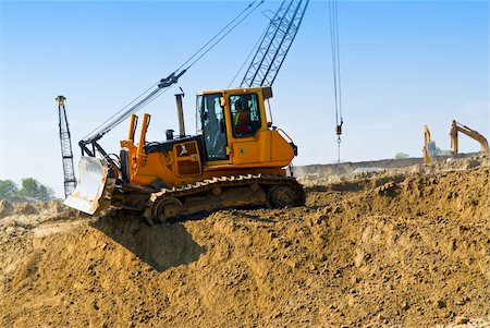 simsearch:400-08375272,k - Yellow bulldozer machines digging and moving earth at construction site Stockbilder - Microstock & Abonnement, Bildnummer: 400-04093606