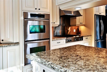 Interior of modern luxury kitchen with stainless steel appliances Foto de stock - Super Valor sin royalties y Suscripción, Código: 400-04093687