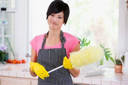 Woman Holding Duster And Wearing Rubber Gloves Foto de stock - Super Valor sin royalties y Suscripción, Código: 400-04106150