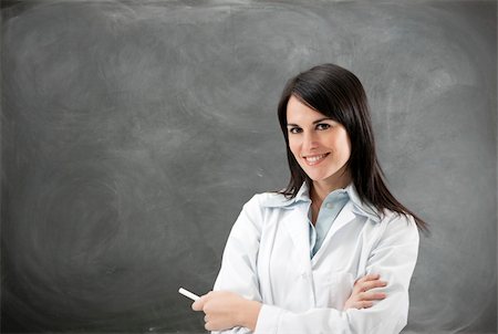 scientist and teacher photo - portrait of mid adult teacher with arms folded against blank blackboard. Copy space Stock Photo - Budget Royalty-Free & Subscription, Code: 400-04106183