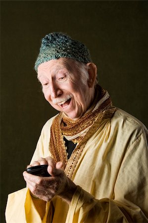 simsearch:400-04596625,k - Wise Man with Knit Cap Using Cell Phone Stock Photo - Budget Royalty-Free & Subscription, Code: 400-04106900