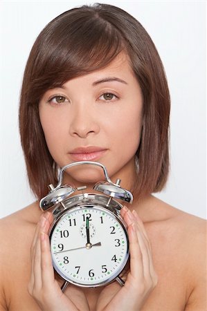 perfect timing - A naturally beautiful oriental woman make up free and holding an alarm clock Stock Photo - Budget Royalty-Free & Subscription, Code: 400-04107056