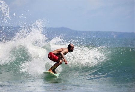 simsearch:400-07217949,k - Young men - the surfer in ocean. Bali. Indonesia Foto de stock - Super Valor sin royalties y Suscripción, Código: 400-04107318