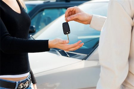 simsearch:400-04107635,k - cropped view of man in car dealership giving car keys to client Photographie de stock - Aubaine LD & Abonnement, Code: 400-04107635