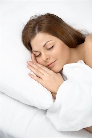 simsearch:400-04107830,k - Portrait of the sleeping young woman in white bed Fotografie stock - Microstock e Abbonamento, Codice: 400-04107832