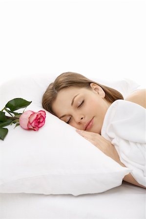 The portrait of the girl sleeping in bed, on a pillow lies a rose Stock Photo - Budget Royalty-Free & Subscription, Code: 400-04107842