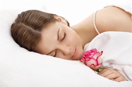 simsearch:400-04107833,k - The sleeping young woman holds a rose in a hand, isolated Stock Photo - Budget Royalty-Free & Subscription, Code: 400-04107843