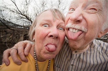 funny old men crazy - Closeup portrait of crazy elderly couple outdoors sticking out tongues Foto de stock - Super Valor sin royalties y Suscripción, Código: 400-04107892