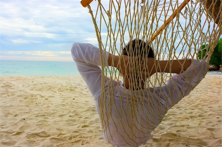 simsearch:400-05097844,k - Young man relaxing on the sand beach Stock Photo - Budget Royalty-Free & Subscription, Code: 400-04109157