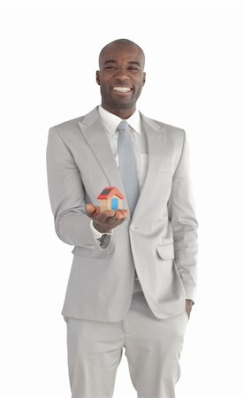 simsearch:400-07291694,k - Young happy Businessman holding a house in his hands Stock Photo - Budget Royalty-Free & Subscription, Code: 400-04109222