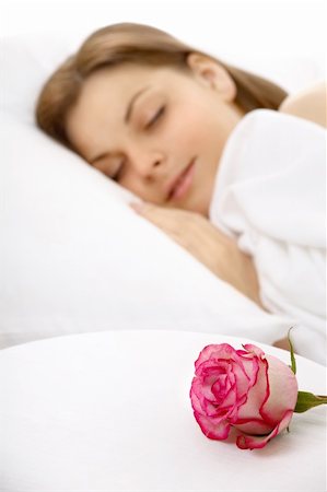 simsearch:400-04107830,k - The girl sleeps in bed, nearby there is a rose, isolated Fotografie stock - Microstock e Abbonamento, Codice: 400-04109900