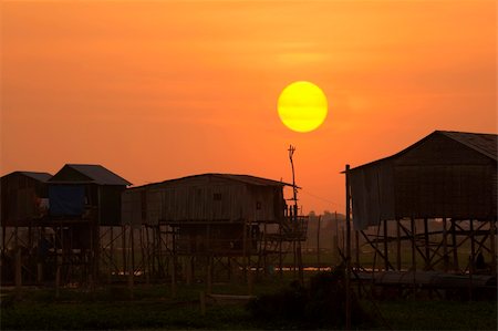 Sunset on a rural village in Cambodia Photographie de stock - Aubaine LD & Abonnement, Code: 400-04100893