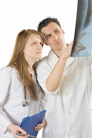 Two doctors, male and female, analysing an x-ray image of a sick patient. Stock Photo - Budget Royalty-Free & Subscription, Code: 400-04101205