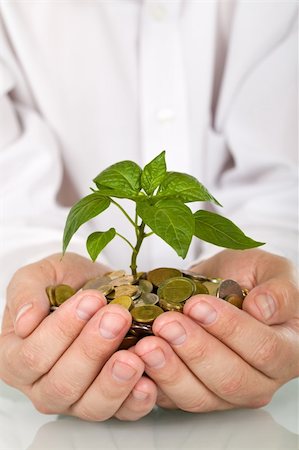 pile hands bussiness - Good investment and money making concept - businessman hands holding pland sprouting from a handful of coins Stock Photo - Budget Royalty-Free & Subscription, Code: 400-04102757