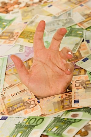 simsearch:400-06860365,k - Man hand reaching out from a layer of euro banknotes - debt and bad finances business concept Stock Photo - Budget Royalty-Free & Subscription, Code: 400-04102761
