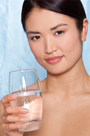 fresh spring drinking water - Studio shot of a beautiful young Japanese woman drinking a glass of mineral water Stock Photo - Budget Royalty-Free & Subscription, Code: 400-04102971