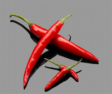 simsearch:400-05732421,k - fresh red chili peppers over grey reflective surface Photographie de stock - Aubaine LD & Abonnement, Code: 400-04103009