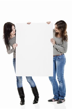 simsearch:400-06071690,k - Portrait of two beautiful young women holding a blank notecard. Photographie de stock - Aubaine LD & Abonnement, Code: 400-04103348