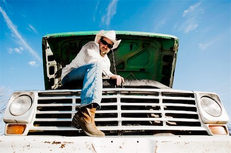 Man in cowboy hat under the hood of truck Stock Photo - Budget Royalty-Free & Subscription, Code: 400-04103474