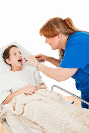 Little boy in the hospital opening his mouth so a nurse can examine his throat.  Isolated on white. Photographie de stock - Aubaine LD & Abonnement, Code: 400-04103851