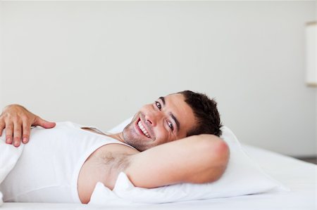 Handsome man lying in his bed smiling Stock Photo - Budget Royalty-Free & Subscription, Code: 400-04114286