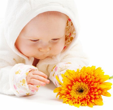simsearch:400-04637418,k - Baby lying on floor and looking at orange flower Stock Photo - Budget Royalty-Free & Subscription, Code: 400-04114323