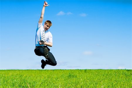 Businessman jumping in the field Stock Photo - Budget Royalty-Free & Subscription, Code: 400-04114347
